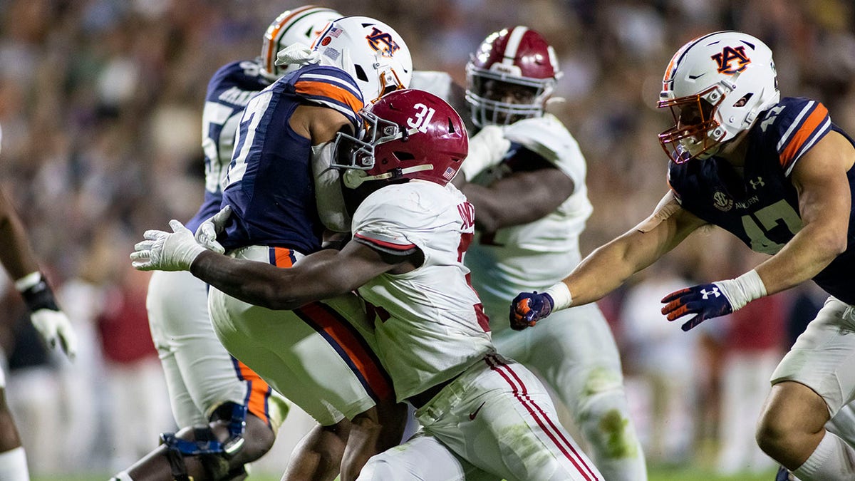 FILE - Alabama linebacker Will Anderson Jr. (31) stops Auburn wide receiver Elijah Canion (17) during the second half of an NCAA college football game, Saturday, Nov. 27, 2021, in Auburn, Ala.  Georgia will play Alabama in an all-Southeastern Conference College Football Playoff national championship on Monday, Jan. 10, 2022.