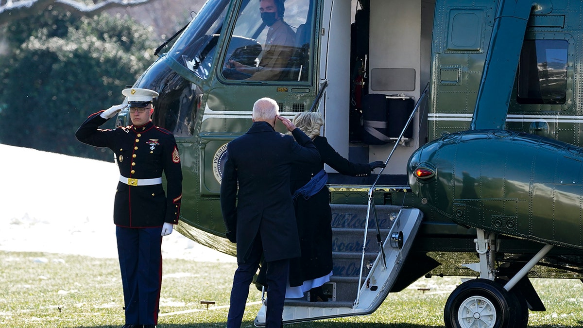 President Biden returns a salute as he and first lady Jill Biden board Marine One on the South Lawn of the White House, Friday, Jan. 7, 2022, in Washington. The Bidens were heading to Colorado and then Nevada.