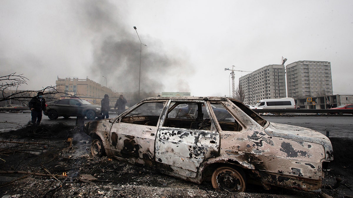 A car, which was burned after clashes, is seen on a street in Almaty, Kazakhstan, Friday, Jan. 7, 2022. 