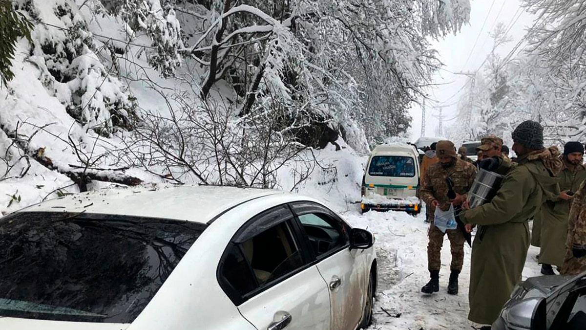 Army members take part in a rescue operation in a heavy snowfall-hit area in Murree, some 28 miles (45 kilometers) north of the capital of Islamabad, Pakistan, Saturday, Jan. 8, 2022. (Inter Services Public Relations via AP)