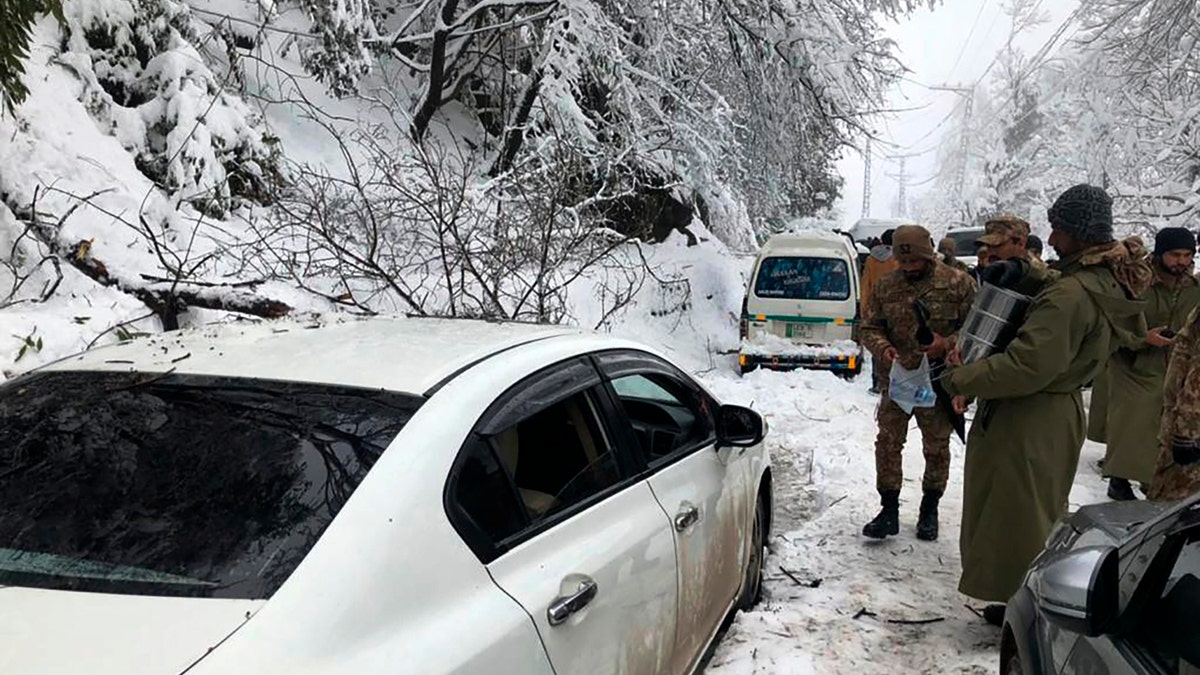 Army members take part in a rescue operation in a heavy snowfall-hit area in Murree, some 28 miles (45 kilometers) north of the capital of Islamabad, Pakistan, Saturday, Jan. 8, 2022. (Inter Services Public Relations via AP)