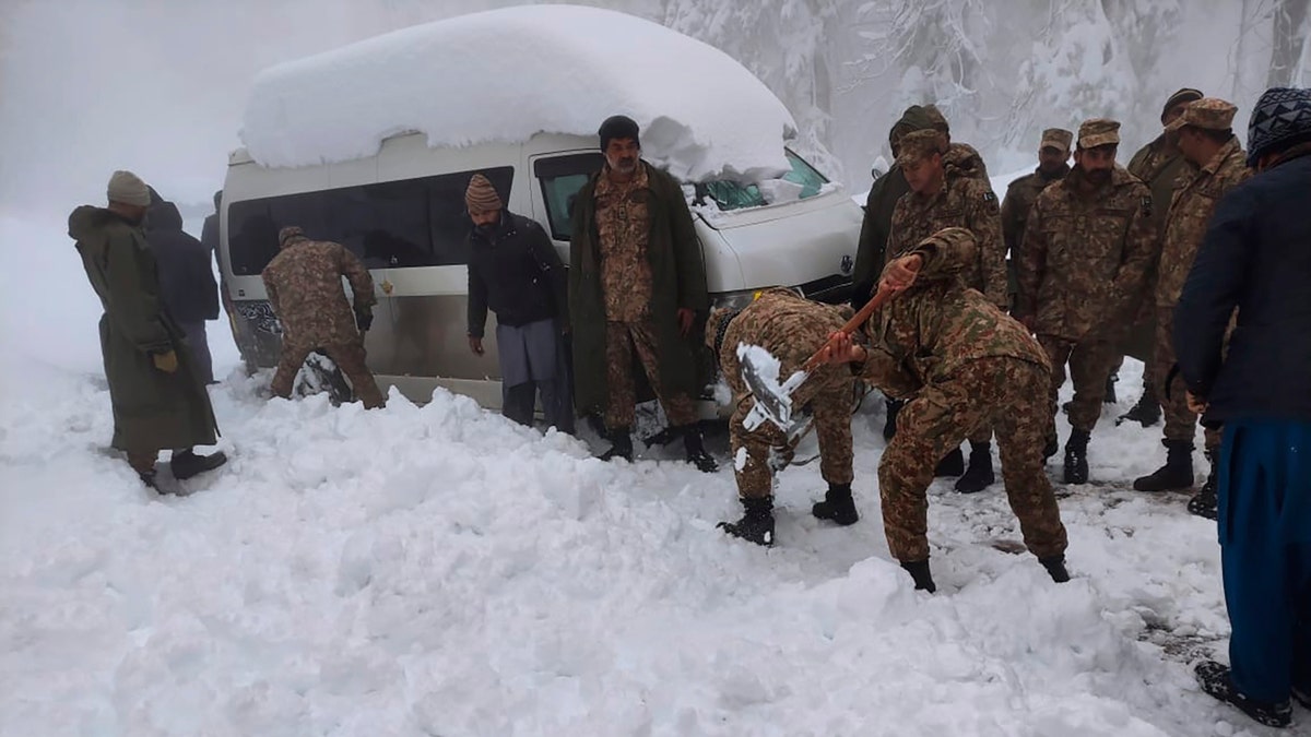 Army troops take part in a rescue operation in a heavy snowfall-hit area in Murree, some 28 miles (45 kilometers) north of the capital of Islamabad, Pakistan, Saturday, Jan. 8, 2022. (Inter Services Public Relations via AP)