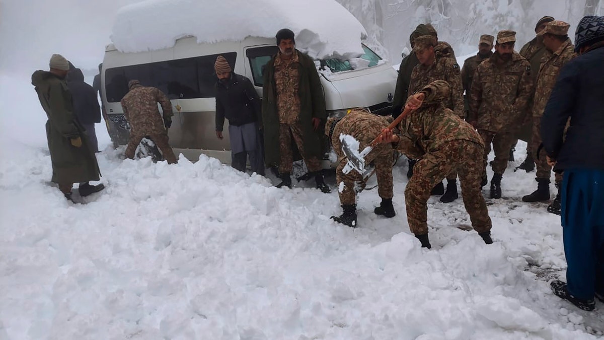 Army troops take part in a rescue operation in a heavy snowfall-hit area in Murree, some 28 miles (45 kilometers) north of the capital of Islamabad, Pakistan, Saturday, Jan. 8, 2022. (Inter Services Public Relations via AP)