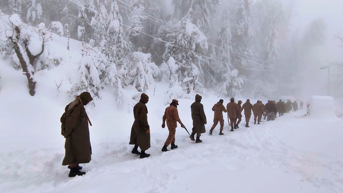 Army members take part in a rescue operation in a heavy snowfall-hit area in Murree, some 28 miles (45 kilometers) north of the capital of Islamabad, Pakistan, Saturday, Jan. 8, 2022. (Inter Services Public Relations via AP)