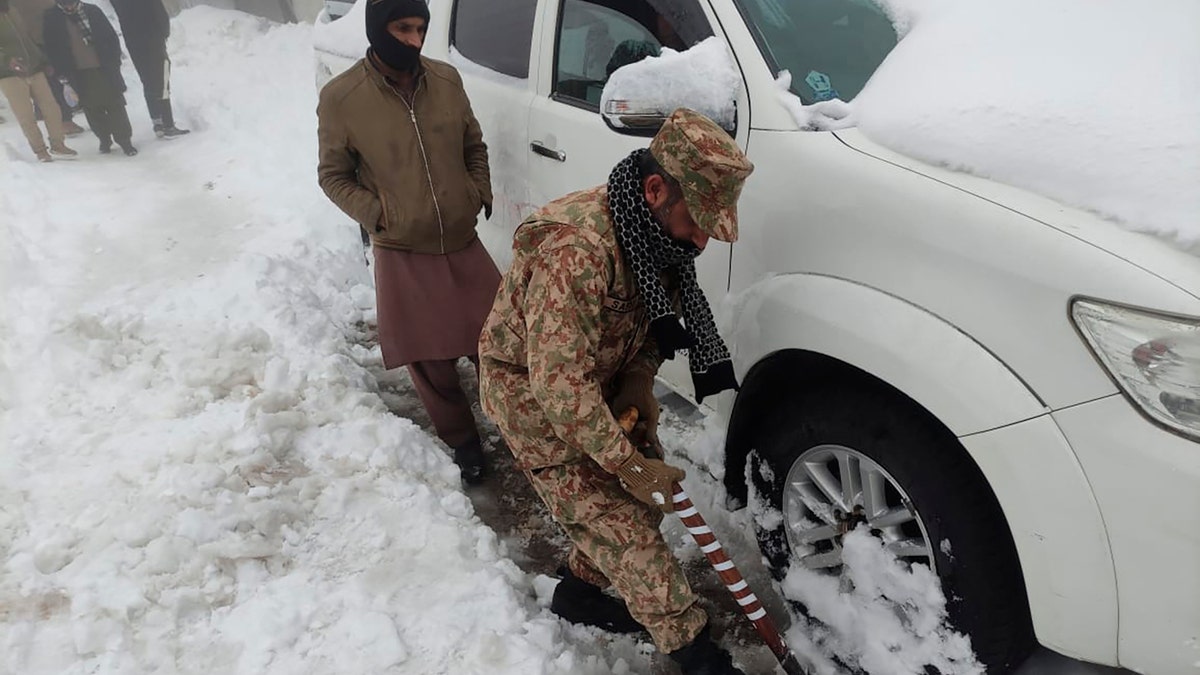 An army soldier takes part in a rescue operation in a heavy snowfall-hit area in Murree, some 28 miles (45 kilometers) north of the capital of Islamabad, Pakistan, Saturday, Jan. 8, 2022. (Inter Services Public Relations via AP)
