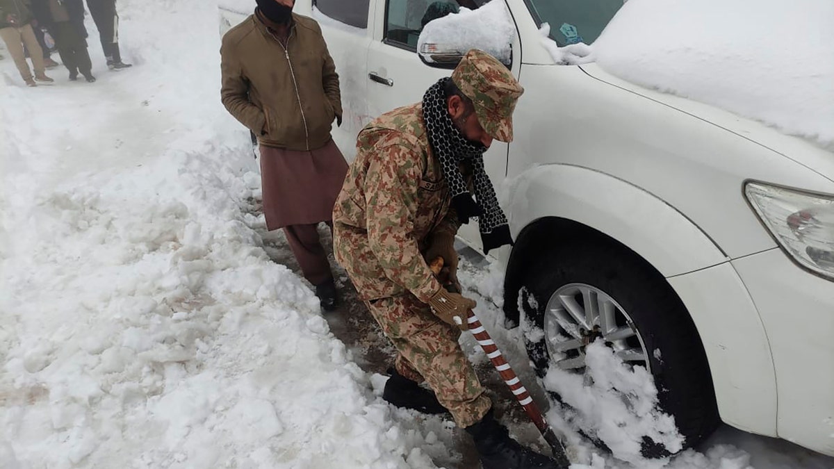 An army soldier takes part in a rescue operation in a heavy snowfall-hit area in Murree, some 28 miles (45 kilometers) north of the capital of Islamabad, Pakistan, Saturday, Jan. 8, 2022. (Inter Services Public Relations via AP)