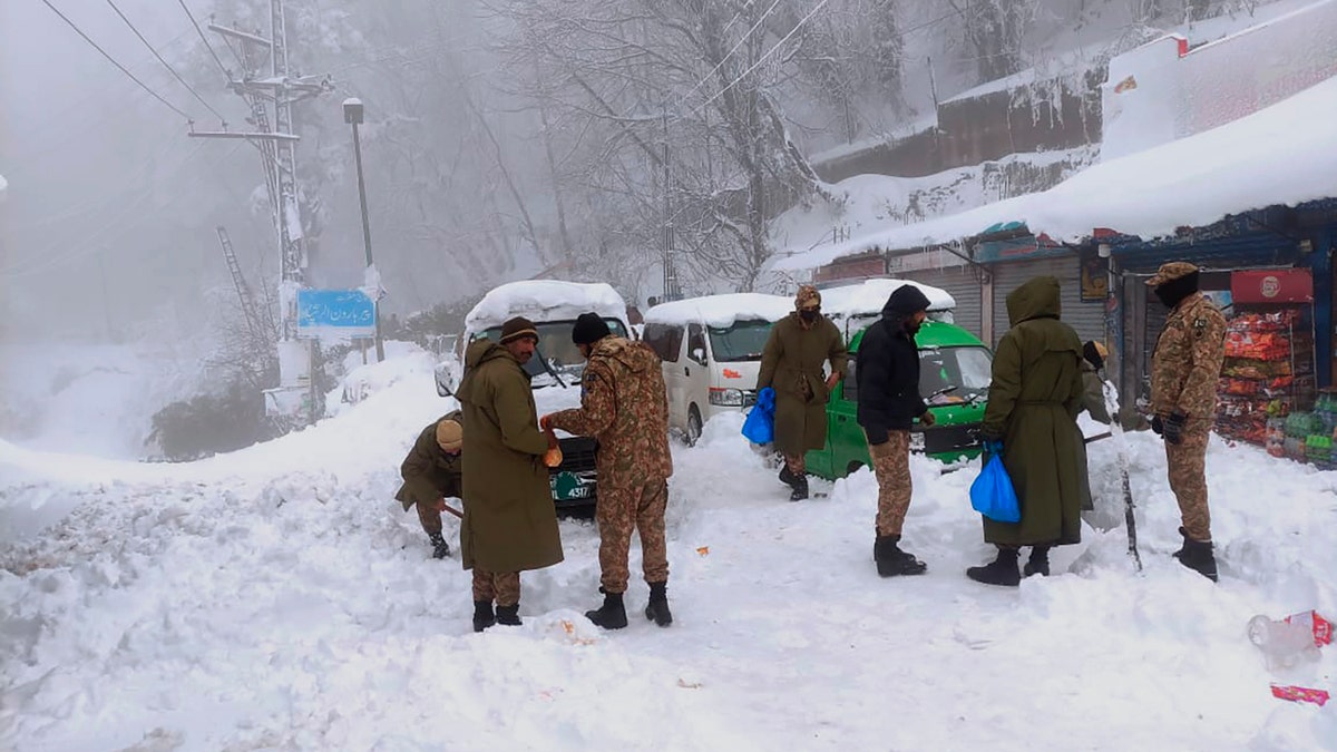 Army members take part in a rescue operation in a heavy snowfall-hit area in Murree, some 28 miles (45 kilometers) north of the capital of Islamabad, Pakistan, Saturday, Jan. 8, 2022.(Inter Services Public Relations via AP)