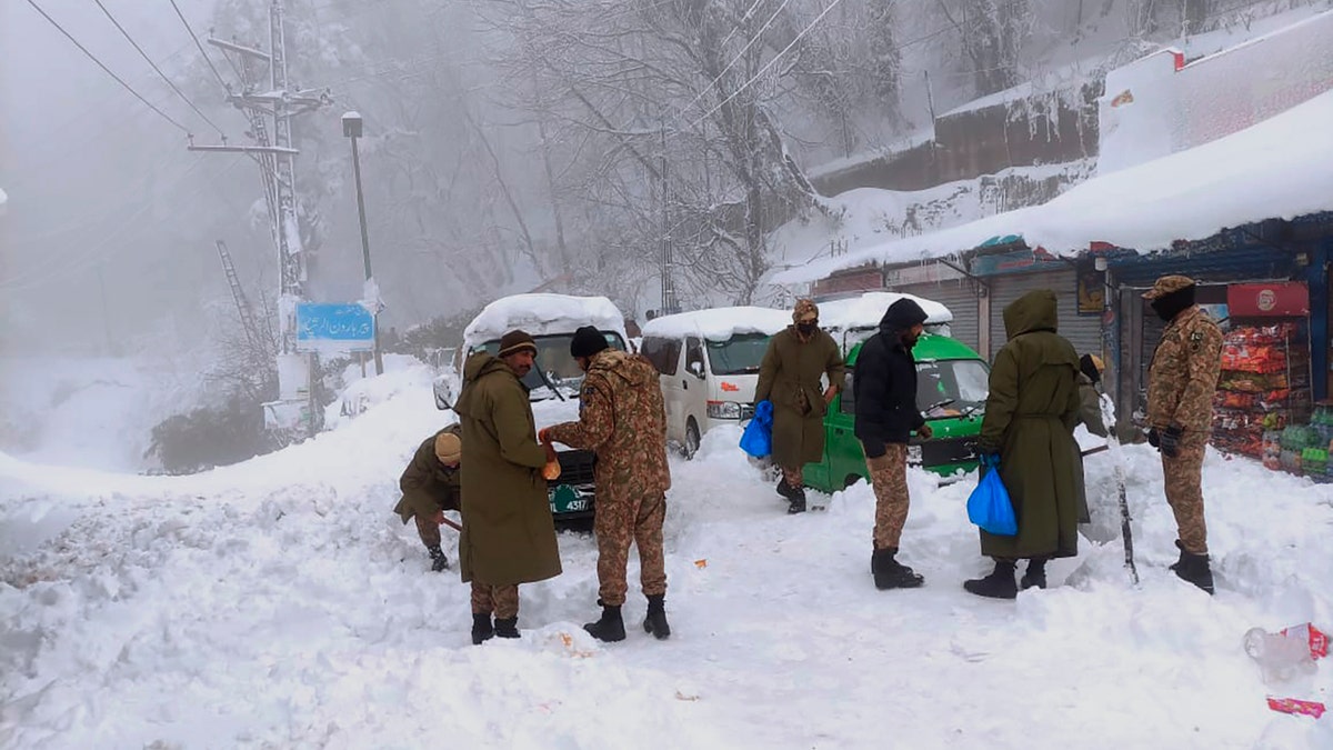 Army members take part in a rescue operation in a heavy snowfall-hit area in Murree, some 28 miles (45 kilometers) north of the capital of Islamabad, Pakistan, Saturday, Jan. 8, 2022.(Inter Services Public Relations via AP)