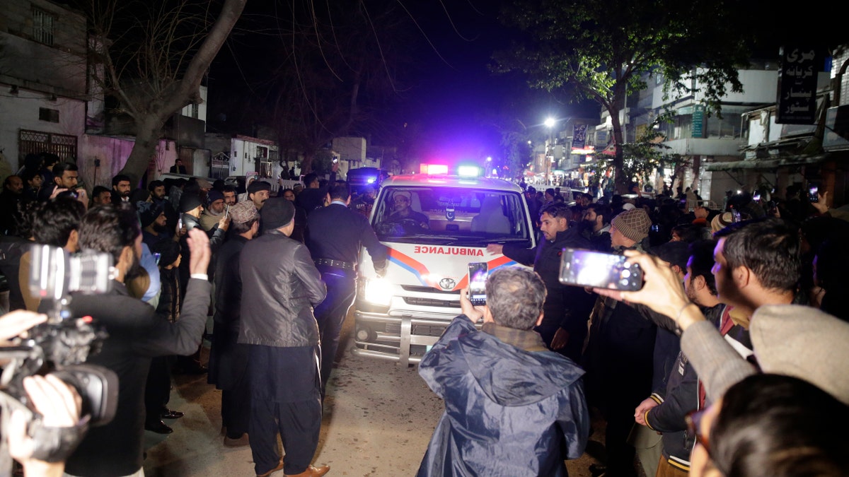Ambulance carry the dead body of victim after they lost their life after a heavy snowfall-hit area in Murree, some 28 miles (45 kilometers) north of the capital of Islamabad, Pakistan, Saturday, Jan. 8, 2022. (AP Photo/Rahmat Gul)