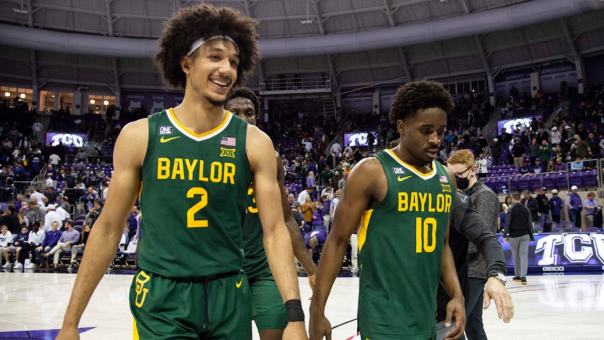 Baylor guard Kendall Brown (2) smiles as he, forward Jonathan Tchamwa Tchatchoua, center back, and guard Adam Flagler (10) walk off the floor after an NCAA college basketball game against TCU in Fort Worth, Texas, Saturday, Jan. 8, 2022.