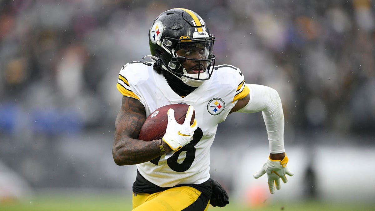 Pittsburgh Steelers wide receiver Diontae Johnson runs with the ball after making a catch against the Baltimore Ravens during the second half of an NFL football game, Sunday, Jan. 9, 2022, in Baltimore.