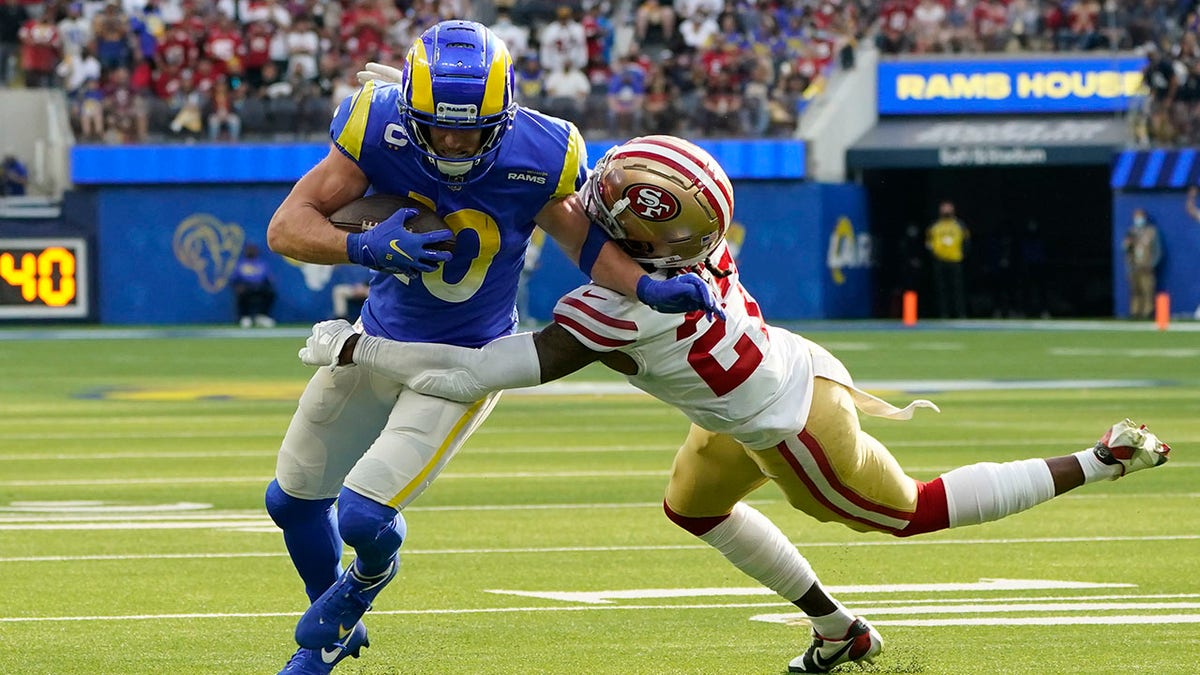 San Francisco 49ers defensive back Dontae Johnson (27) tackles Los Angeles Rams wide receiver Cooper Kupp (10) during the first half of an NFL football game Sunday, Jan. 9, 2022, in Inglewood, Calif.