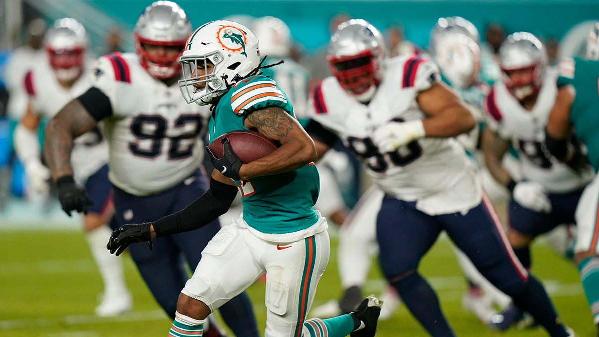 Miami Dolphins wide receiver Jaylen Waddle (17) runs with the ball during the second half of an NFL football game against the New England Patriots, Sunday, Jan. 9, 2022, in Miami Gardens, Fla.