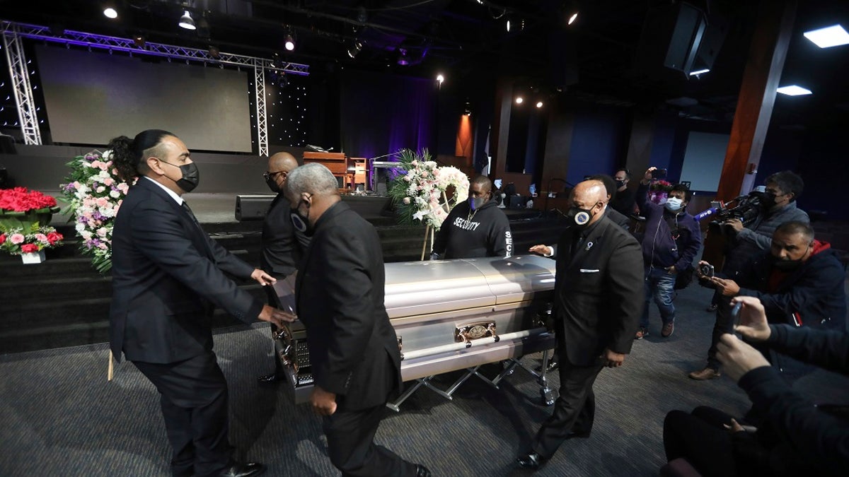 The casket of 14-year-old Valentina Orellana Peralta, killed on Dec. 23, 2021 by an LAPD police officer's stray bullet while shopping with her mother, is readied for her funeral at the City of Refuge Church in Gardena, Calif., on Monday. (AP Photo/David Swanson)