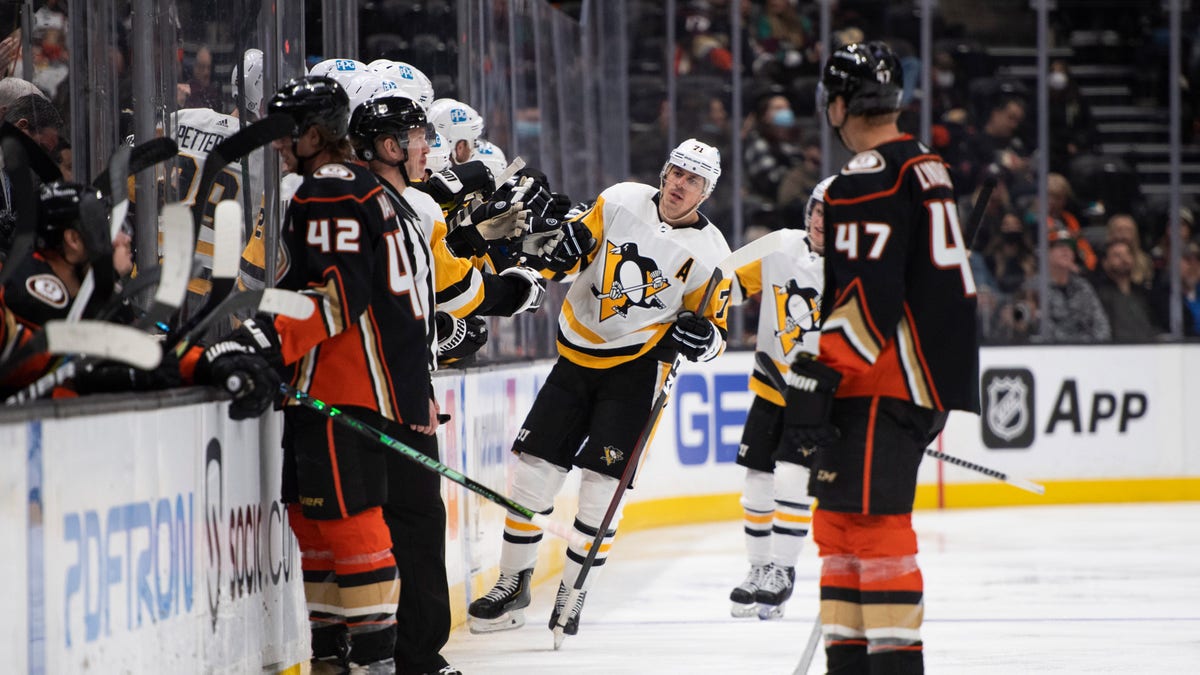 Pittsburgh Penguins center Evgeni Malkin (71) is congratulated on his goal against the Anaheim Ducks in the second period of an NHL hockey game in Anaheim, Calif., Tuesday, Jan. 11, 2022. 