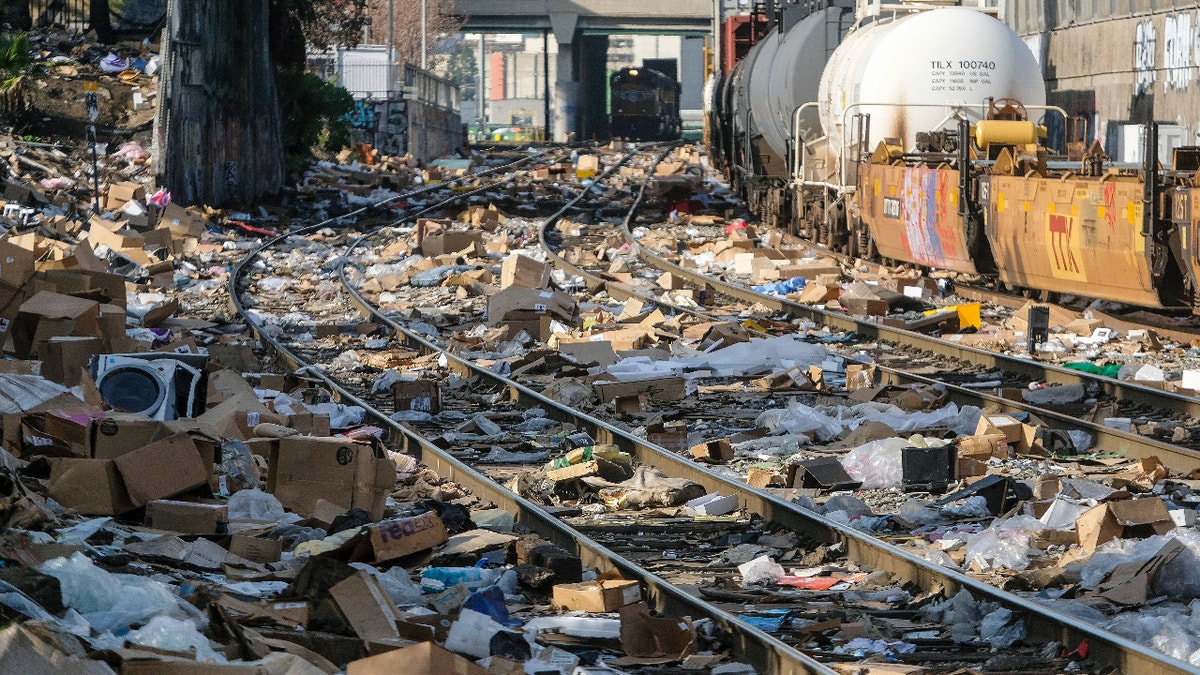 Shredded boxes and packages are seen at a section of the Union Pacific train tracks in downtown Los Angeles Friday, Jan. 14, 2022. Thieves have been raiding cargo containers aboard trains nearing downtown Los Angeles for months, leaving the tracks blanketed with discarded packages. The sea of debris left behind included items that the thieves apparently didn't think were valuable enough to take, CBSLA reported Thursday. (AP Photo/Ringo H.W. Chiu)