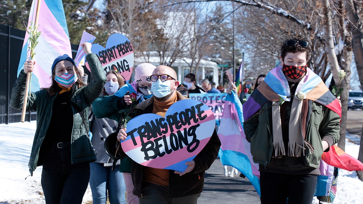 Advocates for transgender people march from the South Dakota governor's mansion to the Capitol in Pierre, S.D., on March 11, 2021. 