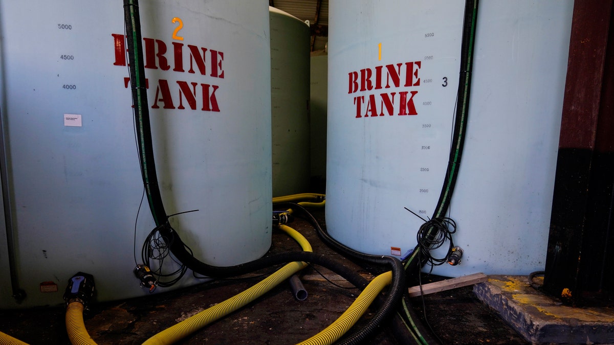 Hoes used to fill brine are seen near brine tank storage bins ahead of a winter storm at the GDOT's Maintenance Activities Unit location on Friday, Jan. 14, 2022, in Forest Park, Ga. (AP Photo/Brynn Anderson)