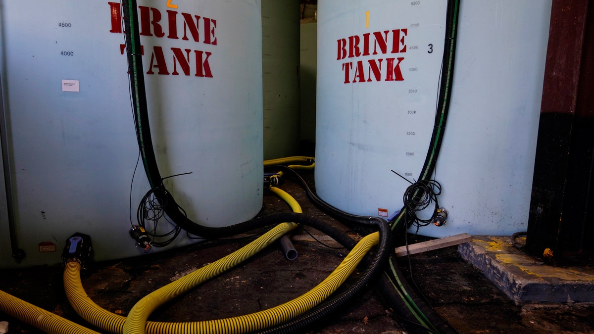 Hoes used to fill brine are seen near brine tank storage bins ahead of a winter storm at the GDOT's Maintenance Activities Unit location on Friday, Jan. 14, 2022, in Forest Park, Ga. (AP Photo/Brynn Anderson)