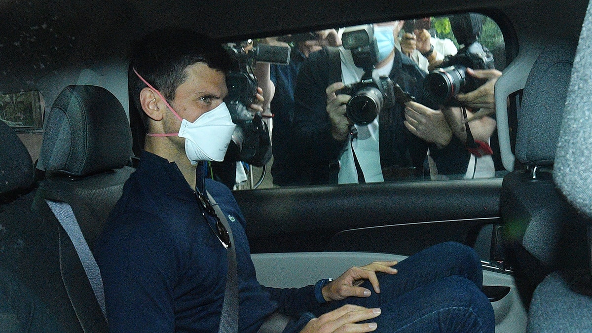 Serbian tennis player Novak Djokovic leaves a government detention facility before attending a court hearing at his lawyer's office in Melbourne, Australia, Sunday, Jan. 16, 2022. (James Ross/AAP via AP)