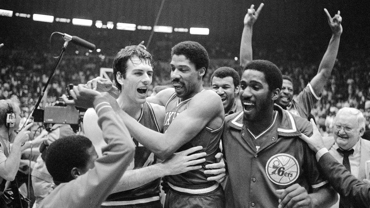 Philadelphia 76ers Bobby Jones, left, embraces Julius Erving after the 76ers defeated the Los Angeles Lakers in four straight games to win the NBA Championship, May 31, 1983. 