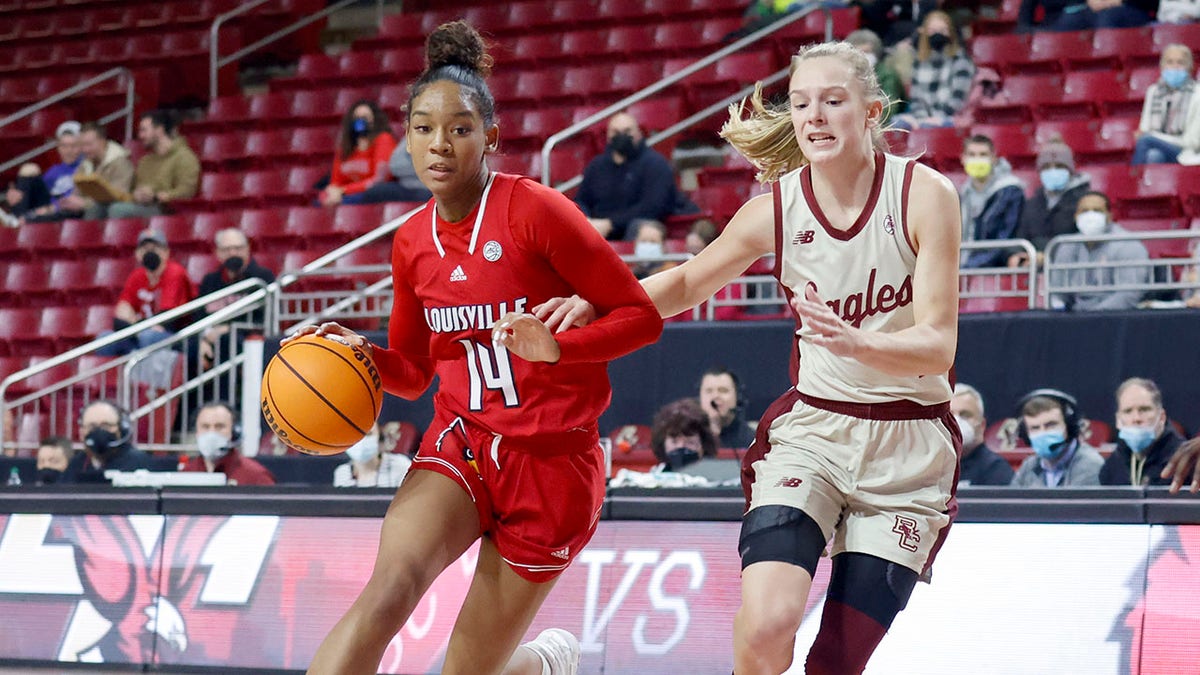 Louisville guard Kianna Smith (14) drives the ball up the court as Boston College guard Cameron Swartz (1) defends during the first half of an NCAA college basketball game, Sunday, Jan. 16, 2022, in Boston.