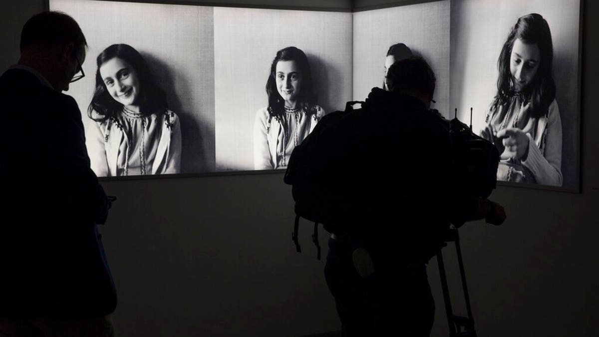 Journalist takes images of pictures of Anne Frank at the renovated Anne Frank House Museum in Amsterdam, Netherlands,