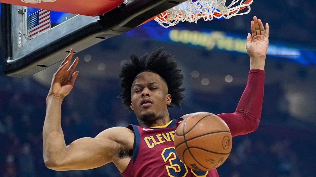 Cleveland Cavaliers' Isaac Okoro dunks against the Brooklyn Nets in the first half of an NBA basketball game, Monday, Jan. 17, 2022, in Cleveland.