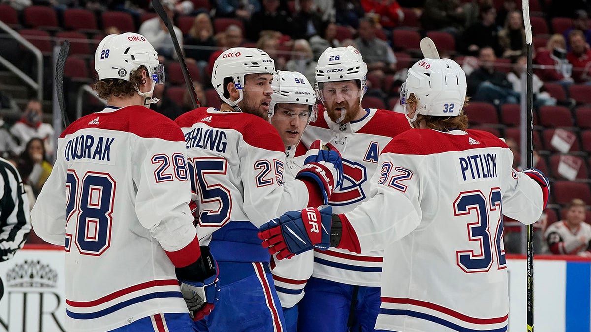 Montreal Canadiens' Christian Dvorak (28), Ryan Poehling (25), Jonathan Drouin (92), Jeff Petry (26), and Rem Pitlick (32) celebrate Poehling's goal during the second period of an NHL hockey game against the Arizona Coyotes, Monday, Jan. 17, 2022, in Glendale, Ariz.