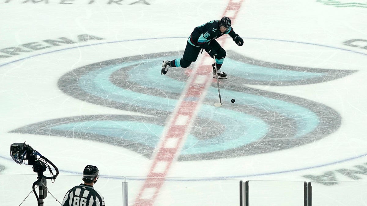 Seattle Kraken left wing Jared McCann takes off from center ice to shoot a penalty shot against the Chicago Blackhawks during the third period of an NHL hockey game, Monday, Jan. 17, 2022, in Seattle. McCann did not score on this play but the Kraken won 3-2 after a shootout following overtime.