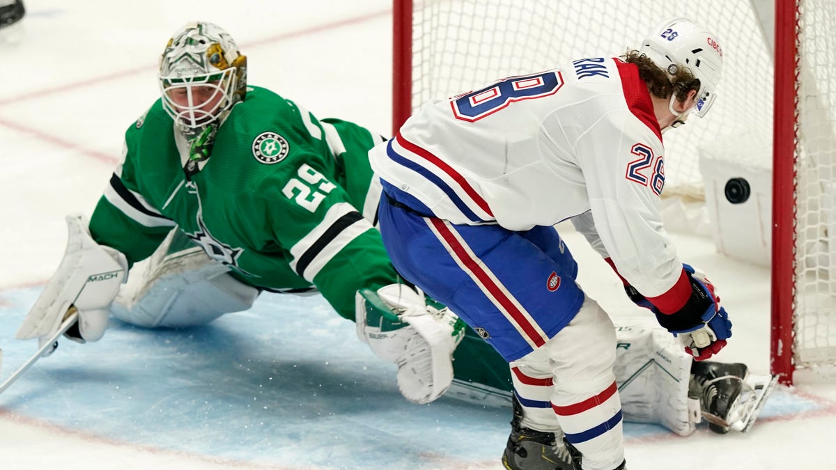 Montreal Canadiens left wing Christian Dvorak (28) scores a goal against Dallas Stars goaltender Jake Oettinger (29) during the third period of an NHL hockey game in Dallas, Tuesday, Jan. 18, 2022. The Canadiens won 5-3. 