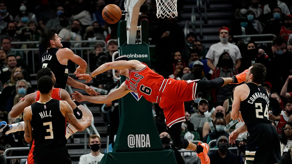 Milwaukee Bucks' Grayson Allen fouls Chicago Bulls' Alex Caruso during the second half of an NBA basketball game Friday, Jan. 21, 2022, in Milwaukee. The Bucks won 94-90.