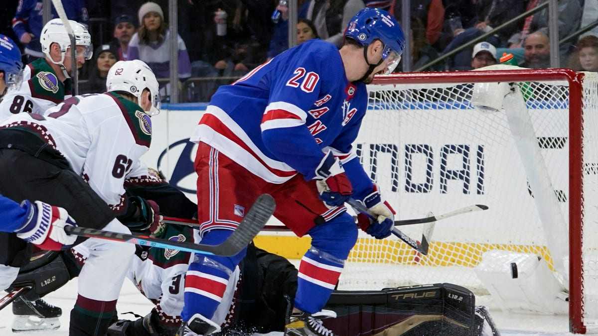 New York Rangers left wing Chris Kreider (20) scores his third goal of the night, past Arizona Coyotes goaltender Scott Wedgewood (31) during the third period of an NHL hockey game Saturday, Jan. 22, 2022, at Madison Square Garden in New York. The Rangers won 7-3. 