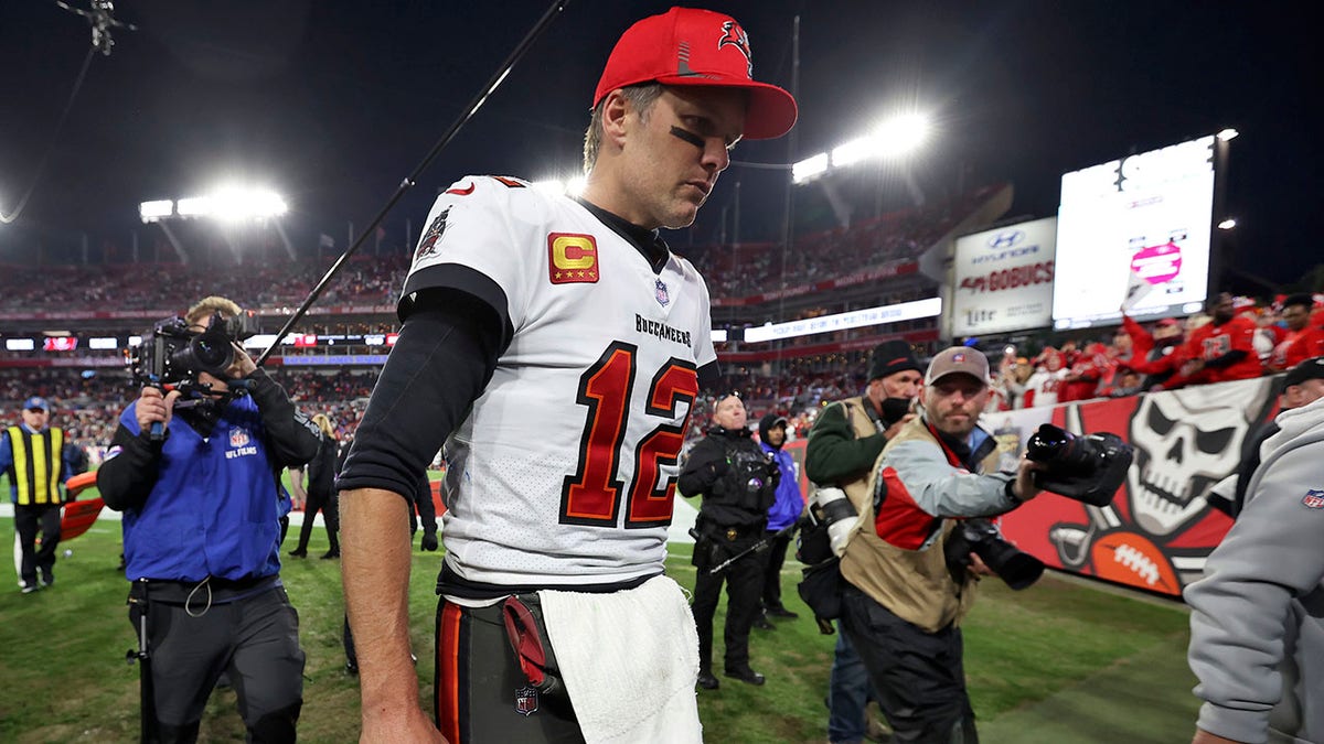 Tampa Bay Buccaneers quarterback Tom Brady (12) reacts as he leaves the field after the team lost to the Los Angeles Rams during an NFL divisional round playoff football game Sunday, Jan. 23, 2022, in Tampa, Fla.