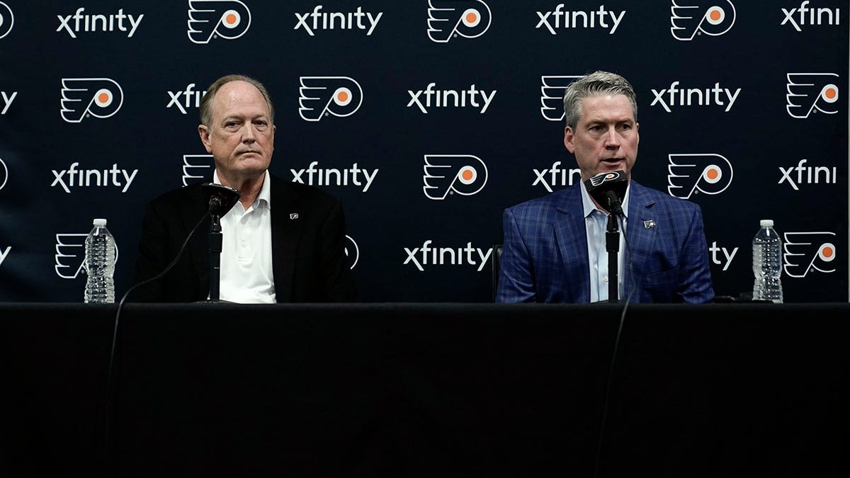 Philadelphia Flyers chairman Dave Scott, left, and Flyers general manager Chuck Fletcher take part in a news conference at the team's NHL hockey practice facility, Wednesday, Jan. 26, 2022, in Voorhees, N.J. The Flyers have lost a team-record 13 straight games.