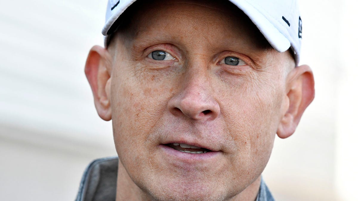 Louisville men's basketball coach Chris Mack speaks to reporters outside the team's practice facility in Louisville, Ky., Wednesday, Jan. 26, 2022. Louisville’s Board of Trustees and the school's Athletic Association have scheduled a joint meeting for Wednesday amid a report that coach Chris Mack will soon be out.