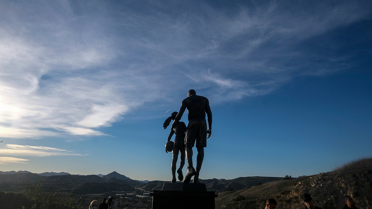 A bronze sculpture honoring former Los Angeles Lakers NBA basketball player Kobe Bryant, his daughter Gianna Bryant, and the names of those who died, is displayed at the site of a 2020 helicopter crash sits in a hillside in Calabasas, Calif, on Wednesday, Jan. 26, 2022. 