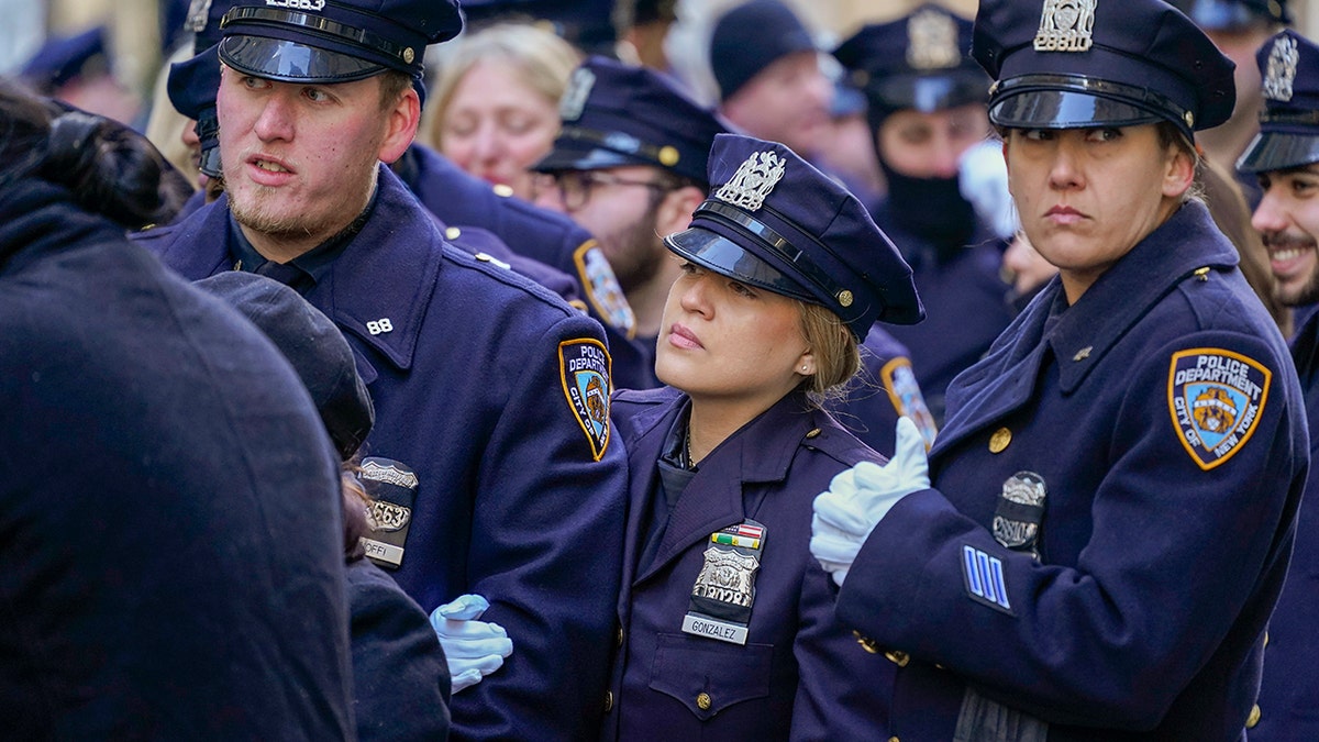 Police officers stand in line outside St. Patricks Cathedral to pay their respects during the wake of New York City Police Officer Jason Rivera