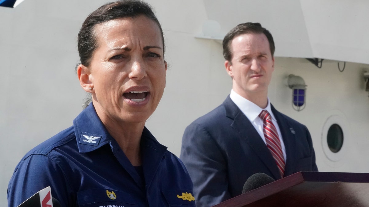 U.S. Coast Guard Capt. Jo-Ann Burdian, foreground, speaks along with Homeland Security Investigations Special Agent in Charge in Miami Anthony Salisbury, rear, during a news conference, Thursday, Jan. 27, 2022, at Coast Guard Sector Miami in Miami Beach, Florida.