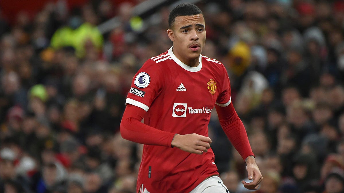 FILE- Manchester United's Mason Greenwood runs during the English Premier League soccer match between Manchester United and Burnley at Old Trafford in Manchester, England, Thursday, Dec. 30, 2021. Manchester United says forward Mason Greenwood will not play or practice with the club until further notice after being accused of sexual assault by a woman, with police also looking into the incident. The statement from the Premier League club was issued on Sunday, Jan. 30, 2022 in response to allegations being posted within videos, photographs and an audio recording that are no longer visible on a woman’s Instagram account.