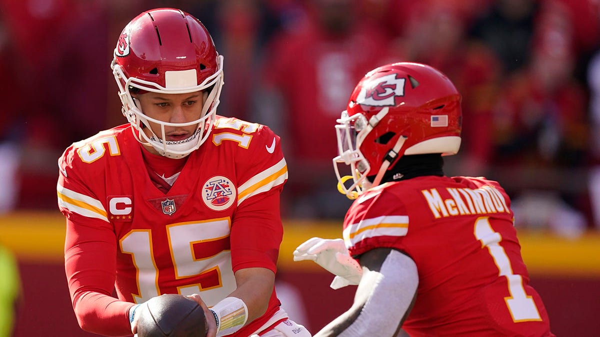 Kansas City Chiefs quarterback Patrick Mahomes (15) hands the ball off to running back Jerick McKinnon (1) during the first half of the AFC championship NFL football game against the Cincinnati Bengals, Sunday, Jan. 30, 2022, in Kansas City, Mo.