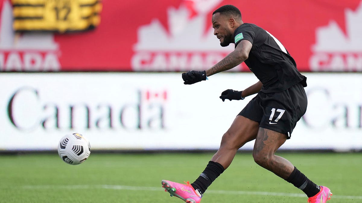 Canada's Cyle Larin scores against the United States during the first half of a World Cup soccer qualifier in Hamilton, Ontario, Sunday, Jan. 30, 2022.