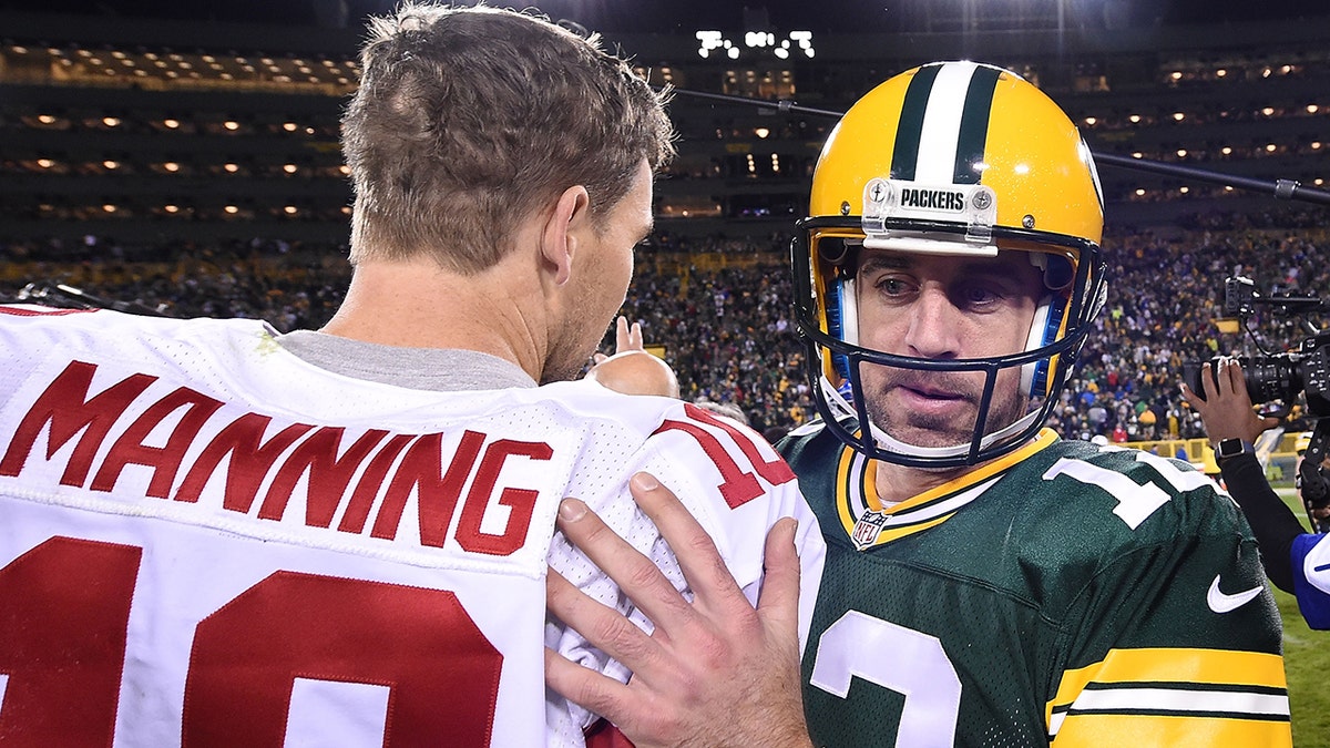 Aaron Rodgers of the Green Bay Packers speaks with Eli Manning of the New York Giants following a game at Lambeau Field on Oct. 9, 2016 in Green Bay, Wisconsin.