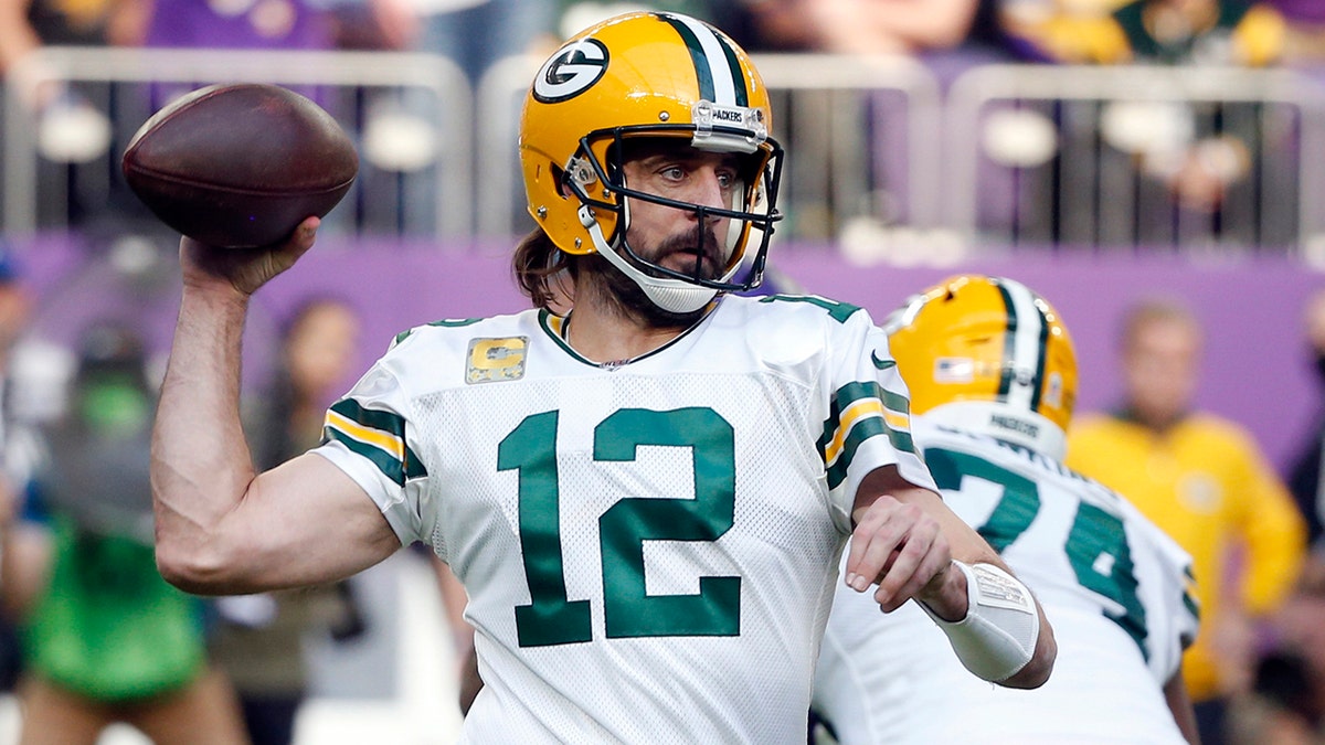 Green Bay Packers quarterback Aaron Rodgers throws a pass during the first half of an NFL football game against the Minnesota Vikings, on Nov. 21, 2021, in Minneapolis.