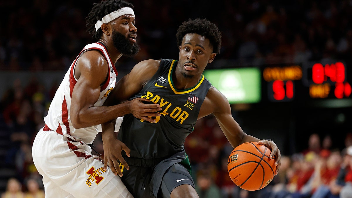 Iowa State guard Tre Jackson (3) fouls Baylor guard Adam Flagler (10) during the second half of an NCAA college basketball game, Saturday, Jan. 1, 2022, in Ames, Iowa. Baylor won 77-72.
