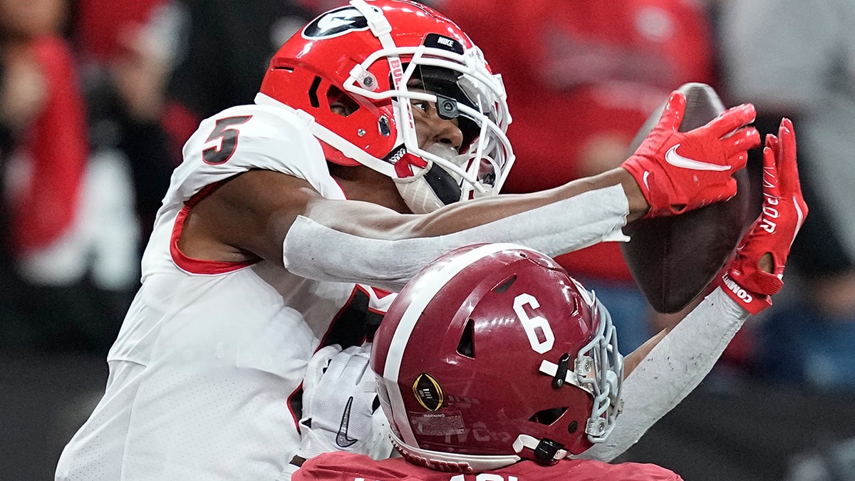 Georgia's Adonai Mitchell catches a touchdown pass over Alabama's Khyree Jackson during the second half of the College Football Playoff championship football game Monday, Jan. 10, 2022, in Indianapolis.
