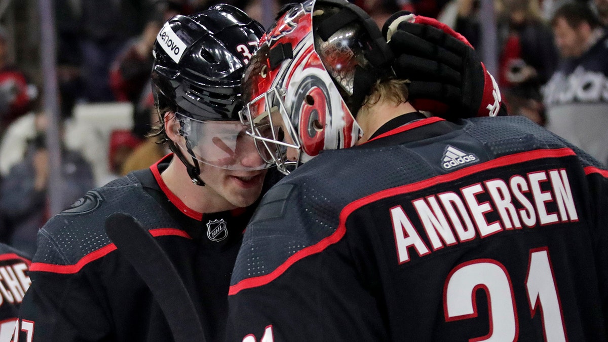 Carolina Hurricanes right wing Andrei Svechnikov, left, congratulates goaltender Frederik Andersen (31) on a win over the Calgary Flames at the end of an NHL hockey game Friday, Jan. 7, 2022, in Raleigh, N.C.