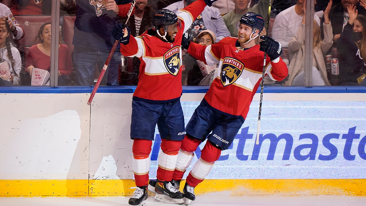 Florida Panthers left wing Anthony Duclair, left, helps center Sam Bennett celebrate his goal during the second period of an NHL hockey game against the Dallas Stars, Friday, Jan. 14, 2022, in Sunrise, Fla.