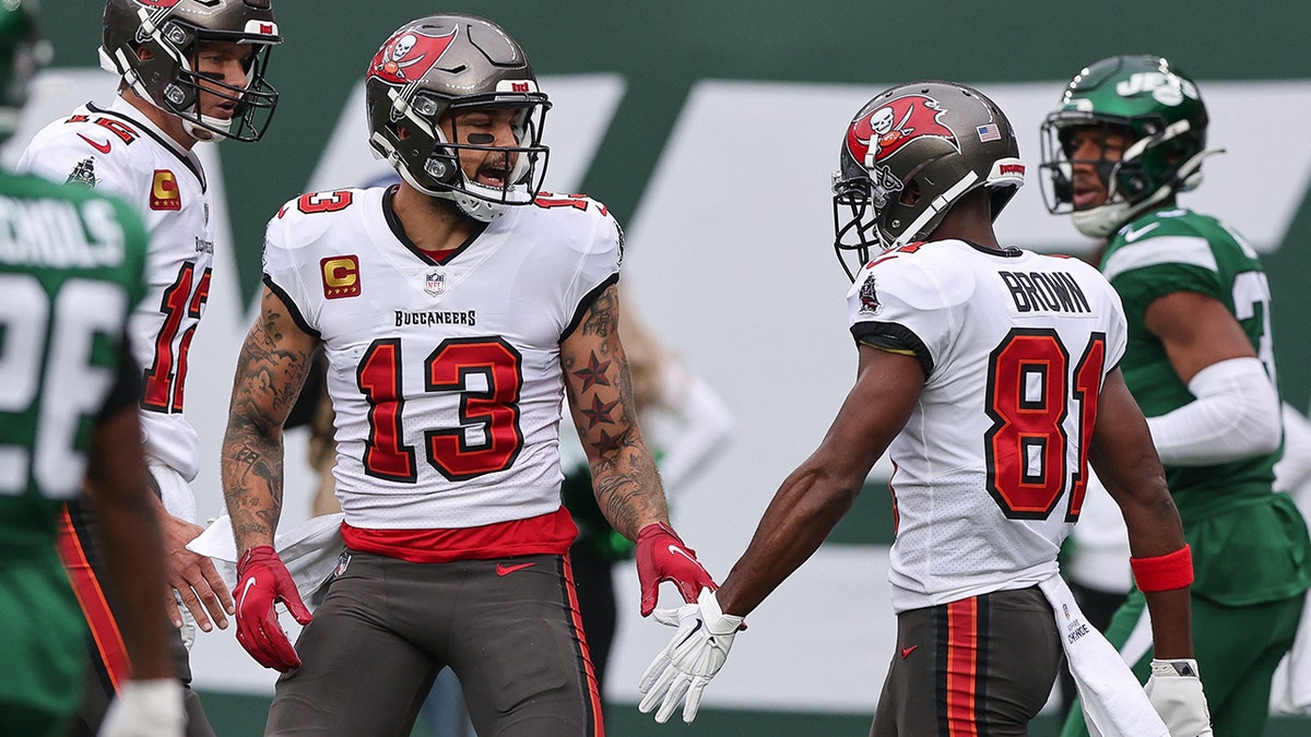 Tampa Bay Buccaneers wide receiver Mike Evans (13) slaps hands with wide receiver Antonio Brown (81) after a touchdown reception during the first half against the New York Jets at MetLife Stadium.