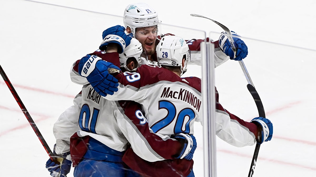 Colorado Avalanche center Nathan MacKinnon (29) celebrates with center Nazem Kadri (91) and right wing Valeri Nichushkin (13)